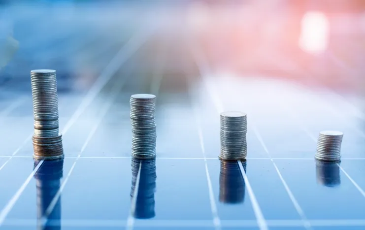 Stacks of coins arranged in ascending order on a reflective surface, symbolizing Trinergy's commitment to financial growth and business success.