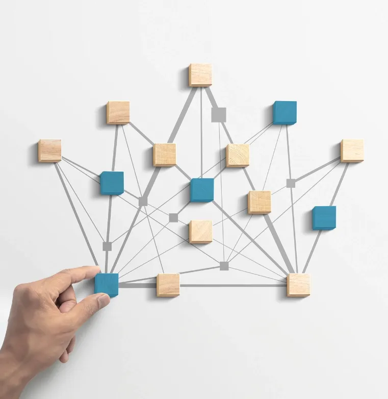 Wooden blocks connected by lines, representing the interconnected technology process at Trinergy.